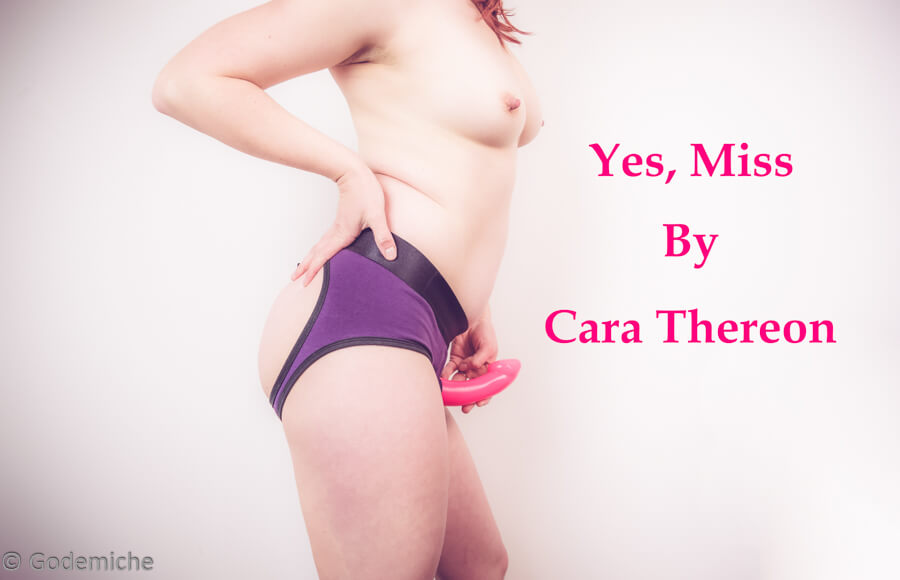 Yes miss by Cara thereon story header. Picture of Monika leaning up against a white wall topless wearing purple strap on pants from Rodeoh and pink dildo