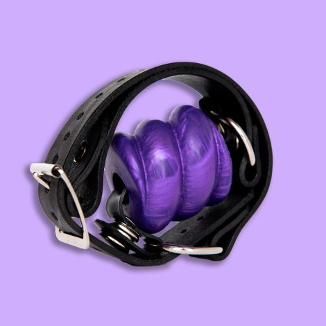 Purple Drool gag with strap wound round it part of Godemiche SIlicone ball gags range